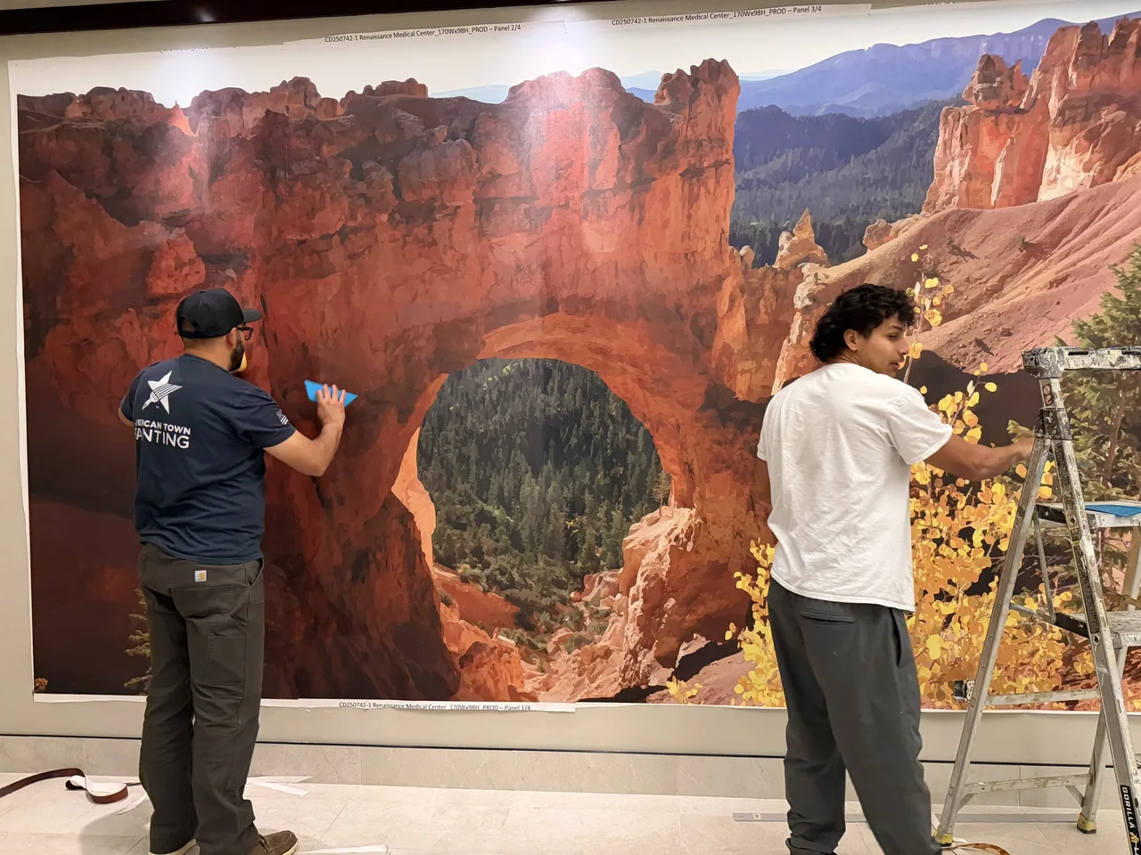 Crew installing a large Bryce Canyon wall mural
