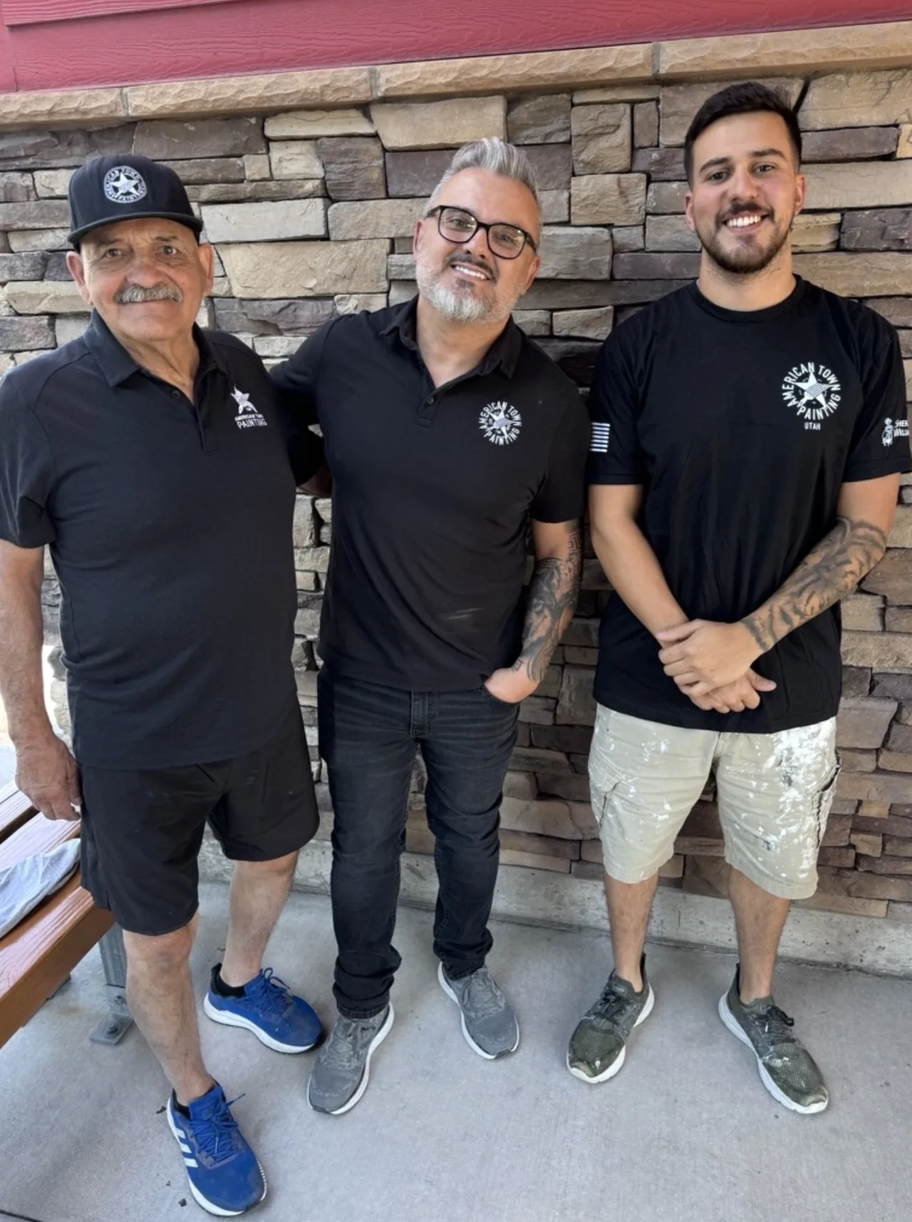 Gabe Pinto, his father and a crew member in American Town Painting shirts