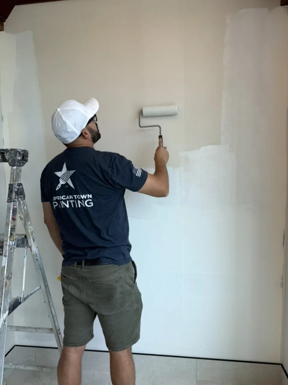 Painter rolling an interior wall