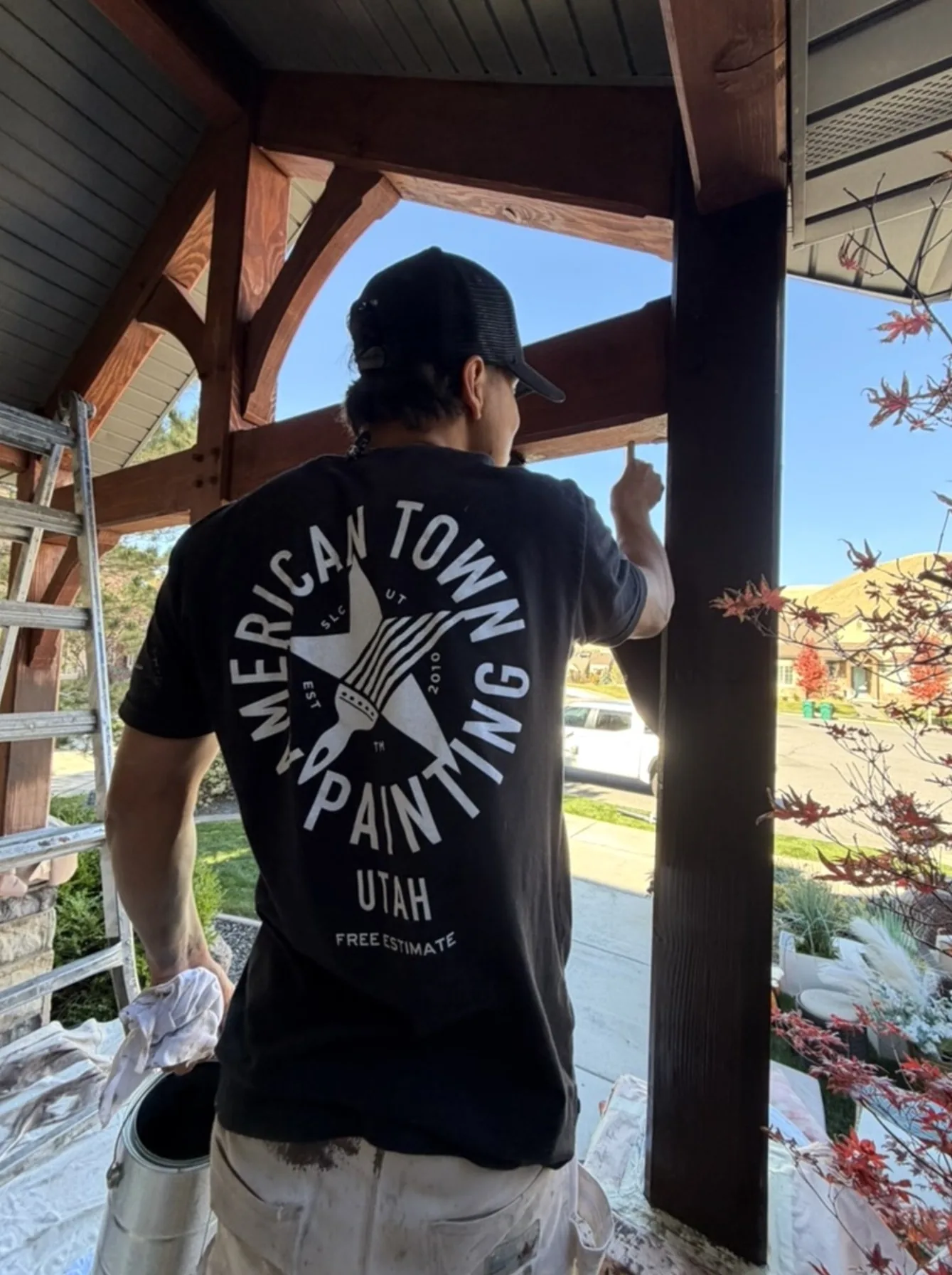 Crew staining porch beams