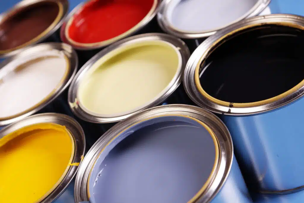 Paint cans in various colors, showcasing the offerings of American Town Painting for creative projects.